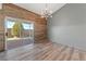 Bright living room with sliding doors to backyard, modern lighting, and beautiful wood floors at 8389 Charlton Valley Ct, Las Vegas, NV 89123