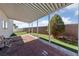 Covered patio with brick and artificial grass at 8389 Charlton Valley Ct, Las Vegas, NV 89123