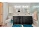 Modern bathroom with double vanity, large mirror, and walk-in shower at 8449 Kettledrum St, Las Vegas, NV 89139