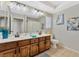 Bathroom boasts double sinks, wood cabinets, and a tiled floor at 8449 Kettledrum St, Las Vegas, NV 89139