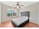 Cozy bedroom with a queen bed, ceiling fan and arched window at 8449 Kettledrum St, Las Vegas, NV 89139