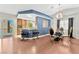 Modern dining area with a glass table and blue accent wall at 8449 Kettledrum St, Las Vegas, NV 89139