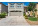 Two-story house with attached garage and landscaped front yard at 8449 Kettledrum St, Las Vegas, NV 89139