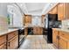 Well-equipped kitchen featuring wood cabinets and black appliances at 8449 Kettledrum St, Las Vegas, NV 89139