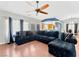 Living room with sectional sofa, hardwood floors, and ceiling fan at 8449 Kettledrum St, Las Vegas, NV 89139