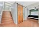 Elegant staircase with wood steps and a barn door at 8449 Kettledrum St, Las Vegas, NV 89139