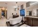 Modern bathroom featuring a soaking tub, dual vanities, and mosaic tile accents at 8560 Foundry Branch Ln, Las Vegas, NV 89113