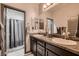 Bathroom featuring double sink vanity with granite countertop and grey cabinets at 8560 Foundry Branch Ln, Las Vegas, NV 89113