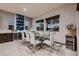 Dining room featuring a glass table, seating for eight, and a wine cooler at 8560 Foundry Branch Ln, Las Vegas, NV 89113