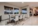 Dining room featuring a glass table, seating for eight, and nice outdoor views at 8560 Foundry Branch Ln, Las Vegas, NV 89113