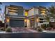 Contemporary two-story home with a three-car garage, enhanced by modern architecture and desert landscaping at 8560 Foundry Branch Ln, Las Vegas, NV 89113