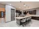 Open-concept kitchen with a granite counter island, modern appliances, and an eating bar at 8560 Foundry Branch Ln, Las Vegas, NV 89113