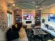 An open living room with a stone accent wall, a ceiling fan, and accent lighting at 8560 Foundry Branch Ln, Las Vegas, NV 89113