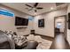 Well lit living room featuring a ceiling fan and recessed lighting above dark wood floors at 8560 Foundry Branch Ln, Las Vegas, NV 89113