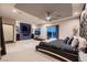 Large main bedroom with a ceiling fan, tray ceiling, and a walk-out balcony at 8560 Foundry Branch Ln, Las Vegas, NV 89113