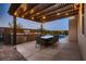 Outdoor kitchen and patio area with built-in grill, dining table and backyard pool at 8560 Foundry Branch Ln, Las Vegas, NV 89113