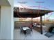 Pergola with lighting shades the outdoor gas kitchen and dining area at 8560 Foundry Branch Ln, Las Vegas, NV 89113