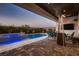 Inviting outdoor area with a pool, spa, seating area, and sleek modern gas heater at 8560 Foundry Branch Ln, Las Vegas, NV 89113