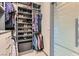 Organized walk-in closet featuring built-in shelving and a glass sliding door at 8560 Foundry Branch Ln, Las Vegas, NV 89113