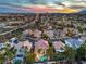 Aerial view of luxury homes with pools and palm trees in a suburban Las Vegas neighborhood at sunset at 8808 Rozetta Ct, Las Vegas, NV 89134