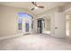 Spacious bedroom features a ceiling fan, mirrored closet, and exterior door with windows at 8808 Rozetta Ct, Las Vegas, NV 89134