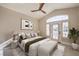 Vaulted ceiling bedroom features a ceiling fan, exterior door, and bench at the foot of the bed at 8808 Rozetta Ct, Las Vegas, NV 89134