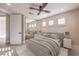 Bright bedroom features a ceiling fan, mirrored closet, and multiple shuttered windows for natural light at 8808 Rozetta Ct, Las Vegas, NV 89134