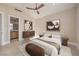 Vaulted ceiling bedroom with elegant furnishings; an ensuite bathroom is visible through the open door at 8808 Rozetta Ct, Las Vegas, NV 89134