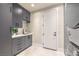 This laundry room boasts modern gray cabinetry, a sink, and a stacked washer and dryer at 8808 Rozetta Ct, Las Vegas, NV 89134