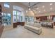 Open concept living room featuring large windows, high ceilings, and a seamless transition to the kitchen area at 8808 Rozetta Ct, Las Vegas, NV 89134