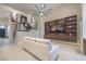 Bright living room featuring a staircase with glass railing, built-in shelving, and a large ceiling fan at 8808 Rozetta Ct, Las Vegas, NV 89134