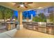 Inviting outdoor kitchen with stone accents, built-in appliances, and ample counter space for entertaining at 8808 Rozetta Ct, Las Vegas, NV 89134