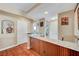 Wet bar with granite counters, wood paneling, and view of stairs at 8908 Rocky Shore Dr, Las Vegas, NV 89117