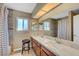 Bright bathroom featuring double sinks, marble countertops, and a spacious shower at 8908 Rocky Shore Dr, Las Vegas, NV 89117