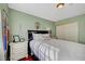 Comfortable bedroom featuring a black bed frame, side tables, and bright, light-green walls at 8908 Rocky Shore Dr, Las Vegas, NV 89117