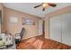 Bedroom featuring wood floors, overhead fan, natural light, and a sliding-door closet at 8908 Rocky Shore Dr, Las Vegas, NV 89117