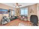 Bedroom with wood floors, overhead fan, natural light, and dark-colored furniture at 8908 Rocky Shore Dr, Las Vegas, NV 89117