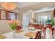 Dining room with seating for six, hardwood floors, chandelier, open to kitchen and living room at 8908 Rocky Shore Dr, Las Vegas, NV 89117