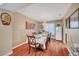 A dining room with hardwood floors, chandelier, seating for six, and plenty of natural light at 8908 Rocky Shore Dr, Las Vegas, NV 89117