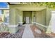 Covered front porch with concrete walkway, small rock garden, and textured stucco walls at 8908 Rocky Shore Dr, Las Vegas, NV 89117