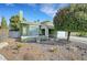 Charming green two-story home with mature landscaping, rock garden, and a well-manicured front yard at 8908 Rocky Shore Dr, Las Vegas, NV 89117