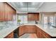 An efficient kitchen layout with granite countertops, wood cabinets, stainless steel sink, and natural light at 8908 Rocky Shore Dr, Las Vegas, NV 89117