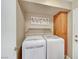 Laundry room with white washer and dryer and a built-in cabinet above at 8908 Rocky Shore Dr, Las Vegas, NV 89117