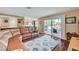 Living Room with a leather couch and sliding glass doors leading to the backyard at 8908 Rocky Shore Dr, Las Vegas, NV 89117