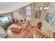 From the top of the stairs, a view of the living room with fireplace and large picture window at 8908 Rocky Shore Dr, Las Vegas, NV 89117