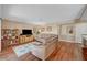 Bright living room with hardwood floors, tan couch, shelving and nice rug at 8908 Rocky Shore Dr, Las Vegas, NV 89117