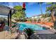 Beautiful backyard with large pool area, mature landscaping, and patio with seating at 8908 Rocky Shore Dr, Las Vegas, NV 89117