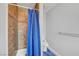 Tiled shower stall with blue curtain, and towel rack at 8908 Rocky Shore Dr, Las Vegas, NV 89117