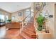 Elegant staircase with wood treads, white risers, and a view of the living room at 8908 Rocky Shore Dr, Las Vegas, NV 89117