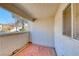 A quaint balcony featuring an orange patterned outdoor rug, and a window with sun shades at 928 Allure Dr, Las Vegas, NV 89128